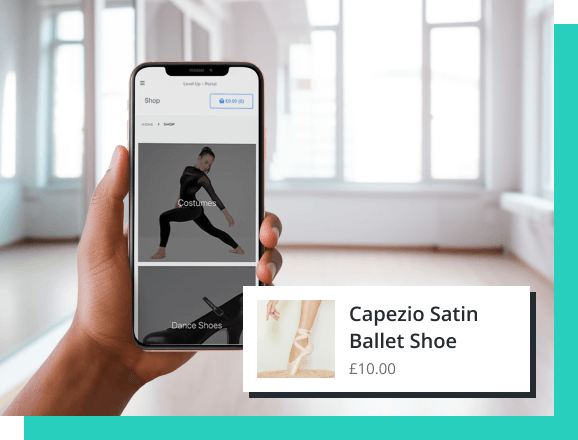 Hand holding phone in dance studio, browsing and ordering ballet shoes from the online shop.
